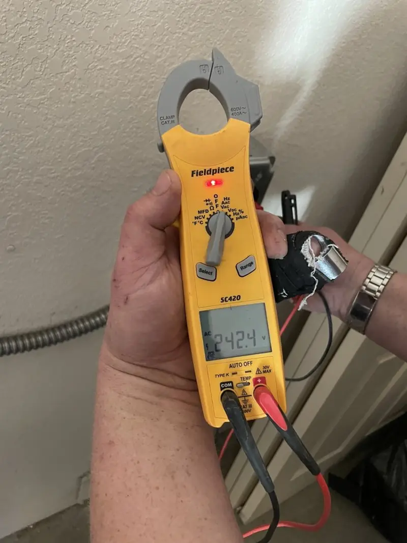 Voltage testing with clamp meter during Electrical Installation Services in Bayshore Gardens